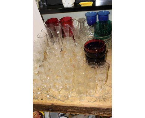 Collection of etched and engraved glassware, pair of ruby glass jugs, coloured glass finger bowls, etc