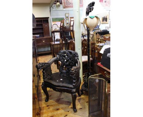 Oriental ornately carved elbow chair and similar carved floor lamp (2)
