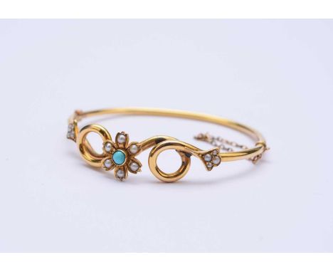A late 19th/early 20th century seed pearl and turquoise hinged bangle, the centre designed as a turquoise and seed pearl flow
