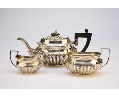 An Edwardian bachelors three piece silver tea service, James Deakin &amp; Sons, Chester 1901, each of oval half reeded form, 