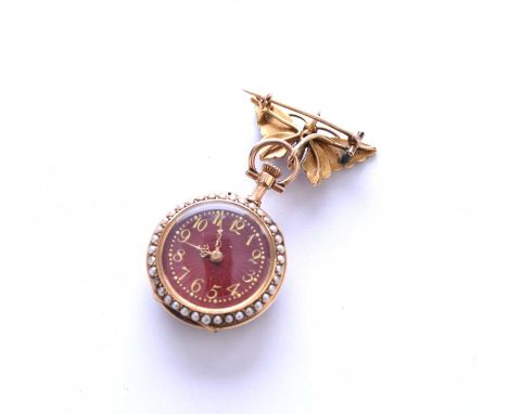 An enamel and seed pearl fob watch, the red guilloche enamel dial with gold Arabic numerals within a border of split seed pea