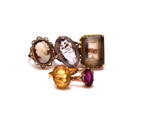 A collection of five stone set rings, comprising; a 9ct gold cameo ring, size M, a 22ct gold band mounted with a yellow paste