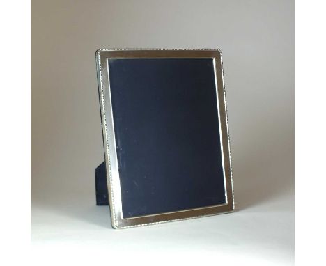 A large silver mounted photograph frame, Carrs of Sheffield, 1990, of rectangular form with beaded rim, 28.5cm x 23.5cm, with