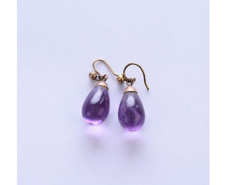 A pair of amethyst drop earrings, the polished amethyst drops mounted with yellow metal hooks, each measure approx 25mm 