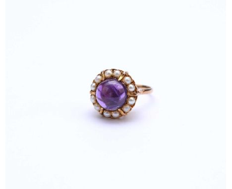 A 9ct gold amethyst and pearl cluster ring, designed as a central round cabochon amethyst claw set within a border of split p