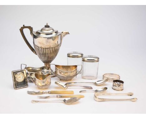 A small collection of silver, comprising; three cream jugs, a caddy spoon, a preserve spoon, a dessert spoon, two silver topp