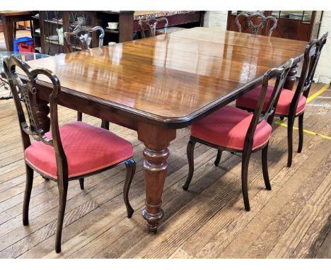 A Victorian mahogany dining table on turned legs and ceramic castors with two extra leaves and six chairs. 74cm x 140cm x 125