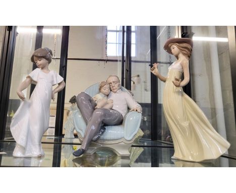 Nao figure of father and child sleeping in armchair 20cm, and two girl figures 22cm and 25cm. (3)