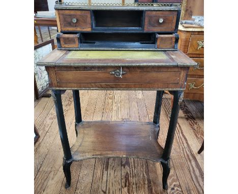 A mahogany writing desk with a galery around the top, two small drawers and a pigeon hole, two smaller drawers and space for 