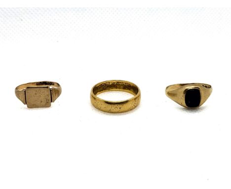 A 22ct yellow gold plain wedding band size P 1/2 5.6gms, a 9ct yellow gold onyx set ring size L 1/2 1.6gms, and a 9ct yellow 