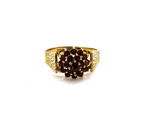 A vintage 9ct yellow gold posy ring set with multiple round tourmaline, central stone damaged. Size N 1/2  3.3gms.