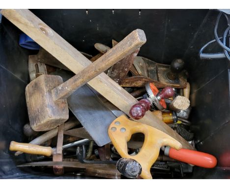 A selection of vintage tools including hand drills, saws, 'T' squares, planes, levels, hammers, mallets, and spanners.