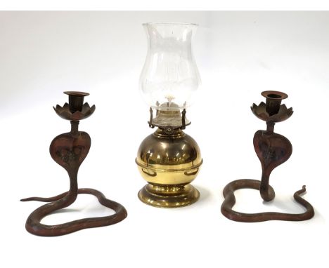 Two cobra shaped candle holders 21cm , and a brass paraffin lamp. (3)