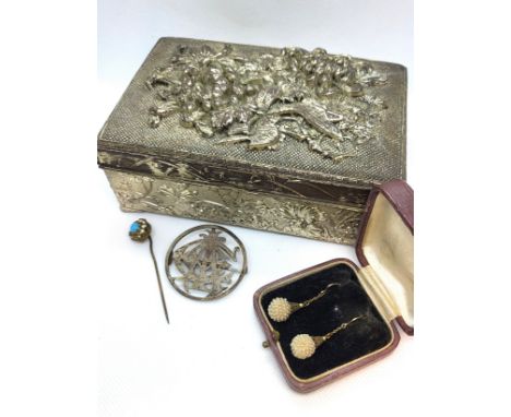 White metal lidded box containing a monogrammed brooch and stick pin, and a pair of drop costume earrings, boxed.