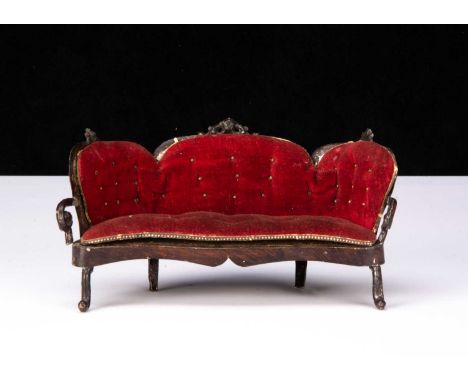 A Rock & Graner tinplate dolls’ house sofa, with dark brown painted wood grained finish and original button velvet upholstery