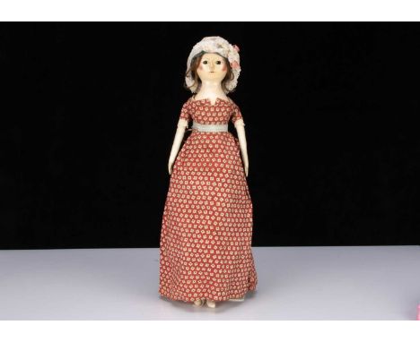 A fine and rare late 18th century English wooden doll, carved, turned and painted with inset dark glass eyes, black dotted ey