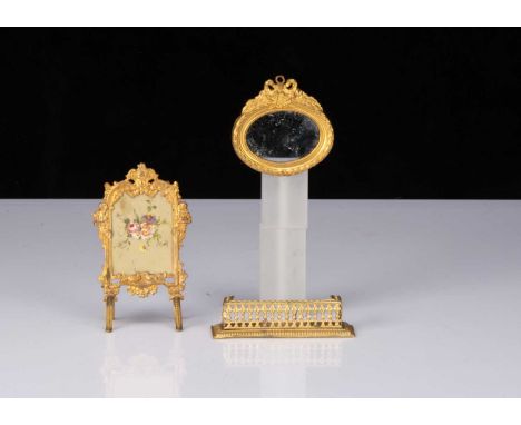 German gilt metal dolls’ house chattels,  a firescreen with hand-painted floral silk middle —4 ¼in. (11cm.) high, a fender an