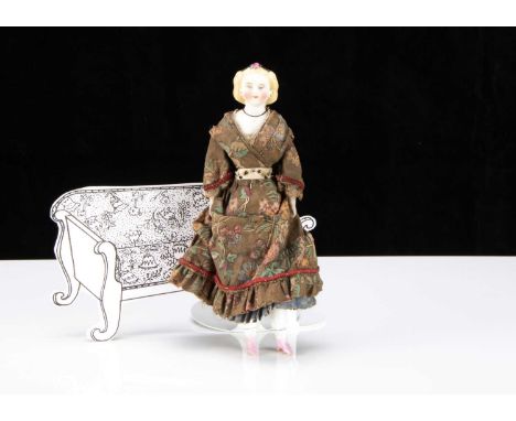 An 19th century larger scale bisque shoulder head dolls’ house doll,  with pale blue painted eyes, red eyelid line, light bro