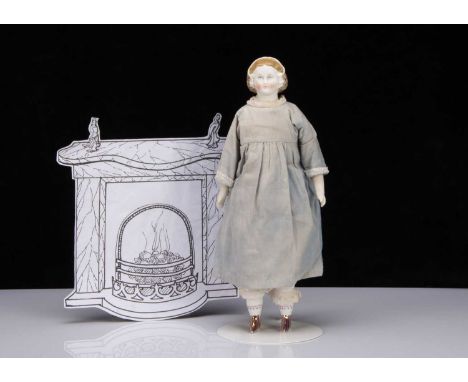 A late 19th century German bisque shoulder head doll with net snood and ribbons in hair,  with blue painted upward glancing e