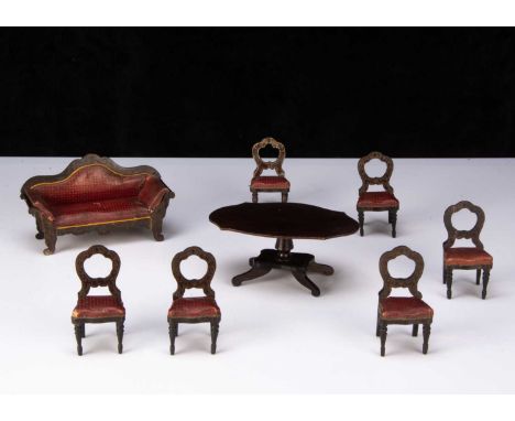 A Waltershausen-type gilt transfer dolls’ house furniture, a sofa with original red and gold leather upholstery —6 ½in. (16.6