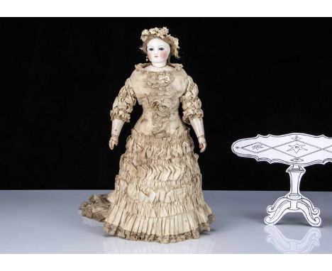 A rare Bru Jeune & Cie fashionable doll with jointed wooden body,  with pressed bisque, fixed dark blue striated glass eyes, 