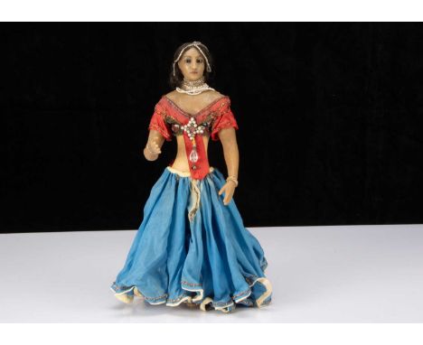 A rare late 19th century English poured wax Indian Princess doll,  possibly Pierotti, of brown wax with inset dark glass eyes