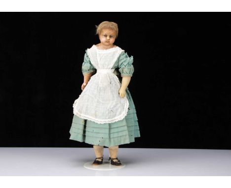 A mid 19th century English poured wax child doll, with head turned slightly to the left, inset bright blue striated glass eye