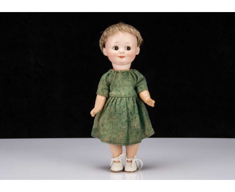 An Armand Marseille 323 googly eyed girl doll,  with brown sleeping side glancing eye, light brown dash and moulded eyebrows,