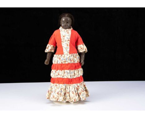 A rare 19th century English black poured wax child doll,  with inset dark eyes, down turned mouth, inserted centre-parted bla