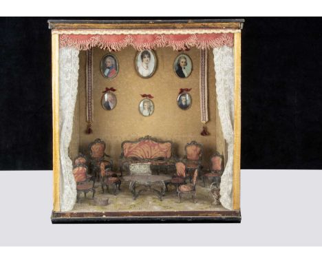 A room setting display case with ‘silver’ white metal filigree dolls’ house furniture,  comprising sofa —6 ¼in. (16cm.) wide,