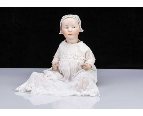 A rare Gebruder Heubach 7977 Baby Stuart,  with grey intaglio eyes, a closed downturned mouth, moulded white bonnet with two 