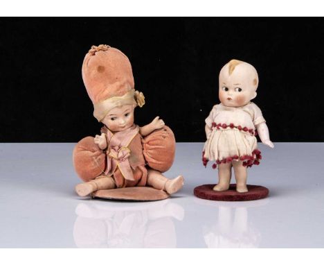 *SALEROOM ANNOUNCEMENT - THE RIGHT HAND DOLL HAS LEFT ARM REPLACE WITH SUITABLE ANTIQUE ARM.*Two small German all-bisque comi