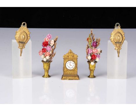 A German gilt-metal dolls’ house mantel clock, with enamel dial —2in. (5cm.) high; two gold painted cast-metal wall mounted c