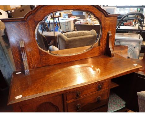 Edwardian oak mirror back sideboard with three central drawers and cupboards with a mirrored back, 120 x 60 cm. Not available