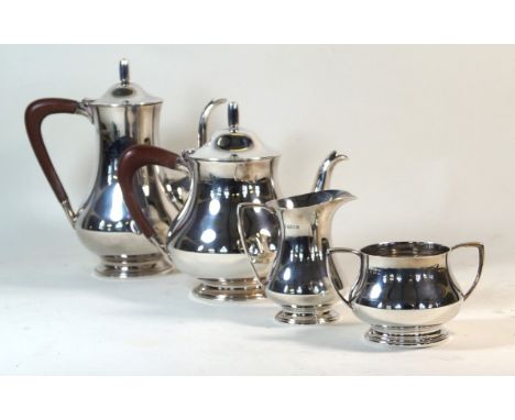 A contemporary hallmarked silver four piece tea service
Comprising teapot, hot water pot, twin handled sugar bowl, milk jug, 
