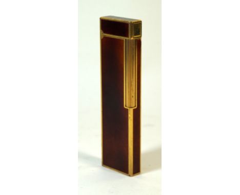 A large Dupont Laque de chine table lighter circa 1980
The gilt and tortoiseshell effect lighter with flip up lid, the base s
