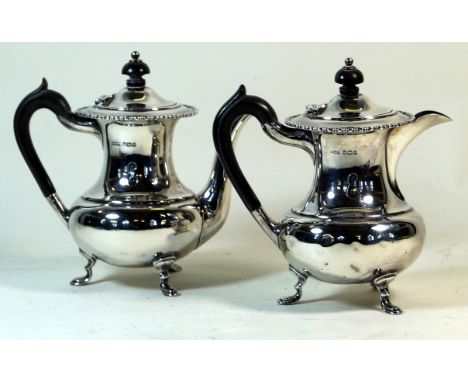 A George V hallmarked silver two piece tea service
Comprising teapot and hot water jug, each of baluster form with cast beade