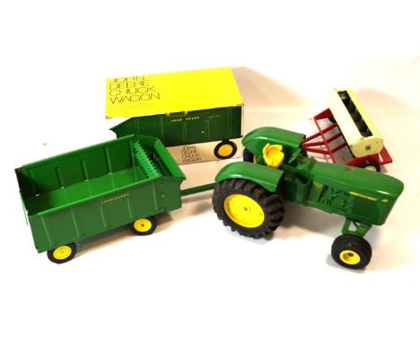 An unboxed ERTL model of a 5020 diesel John Deere Tractor
Together with a boxed chuck wagon and boxed grain drill with revolv