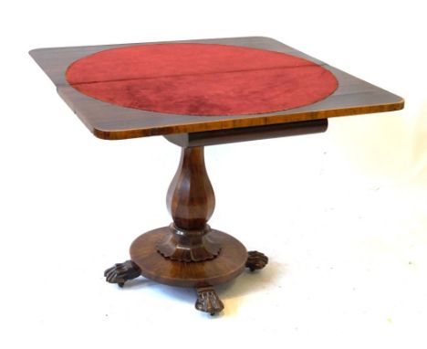 A William IV rosewood card table
The hinged and swivel top above carved and shaped frieze, raised on octagonal baluster colum