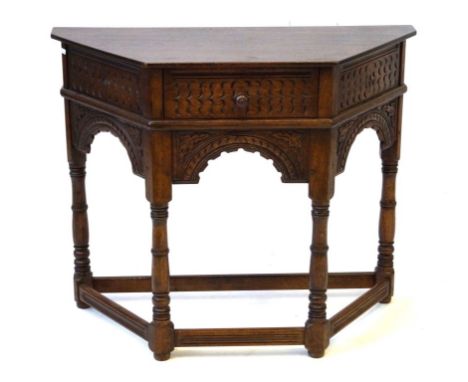 A 17th Century style oak console table, 20th Century
The shaped topped with single frieze drawer and chisel carved decoration