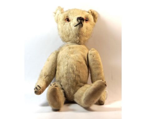 A blonde plush teddy bear - believed to be French, circa 1920
With glass button eyes, pointed snout and articulated limbs, he