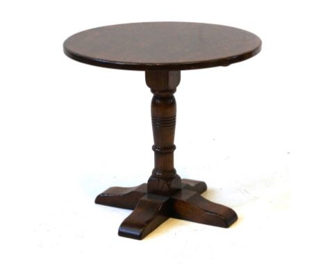 A 17th Century style solid oak wine table, 20th Century
The circular top raised ring turned column terminating on four outspl