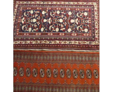 Caucasian rug on a mainly blue ground, late 20th Century
The central panel with multiple florally decorated medallions flanke