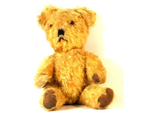 A Lefrey gold plush 1950s teddy bear 
With glass button eyes and articulated limbs, height 38cm.