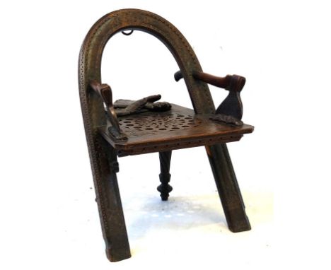 A Russian carved oak trompe l'oeil armchair after Vasilil Petrovich Shutov, late 19th Century
The curved back rest and front 