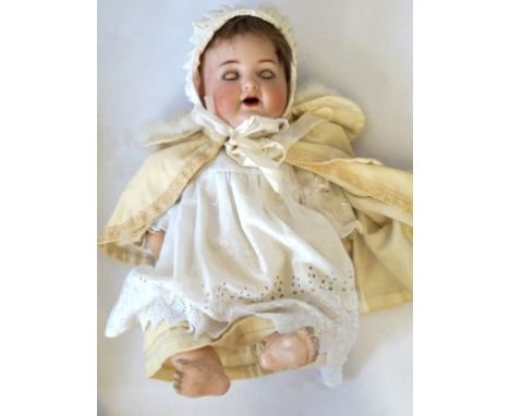 A German bisque headed doll 
With brown wig, blue eyes, open mouth, impressed K*R Simon & Halbig 126, with composition body a