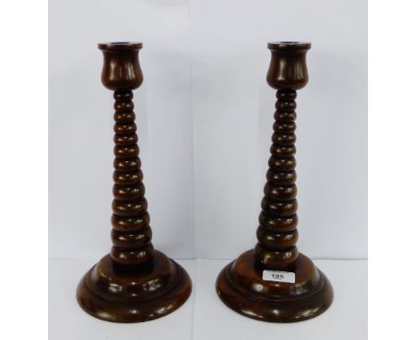 A pair of wooden bobbin turned candlesticks, 30cm high, (2)