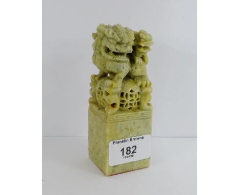 A green hardstone Chinese seal with temple dogs on a rectangular plinth base, 12cm high