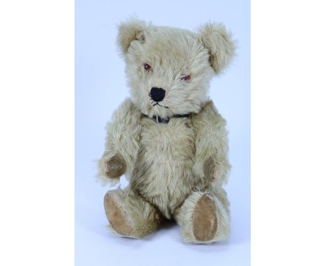 Light brown post-war Chiltern mohair Teddy bear, with orange plastic eyes, black stitched nose and mouth, swivel head and joi