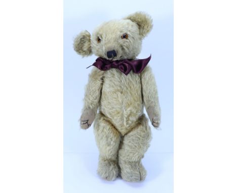 A Merrythought Teddy bear, English 1930s, the light brown bear with orange glass eyes, black stitched nose, mouth and webbed 